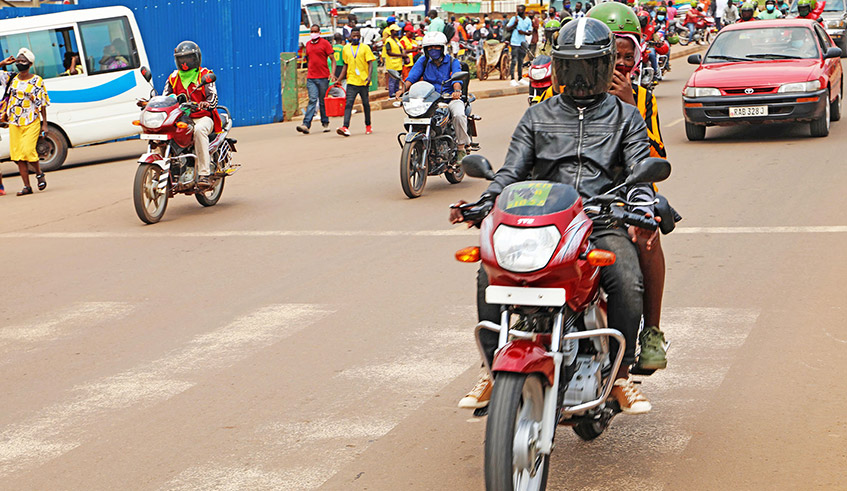 Taxi-moto operators on a road in Kigali. They are worried about the future of their business due the hike in bike insurance premiums. / Photo: Craish Bahizi.