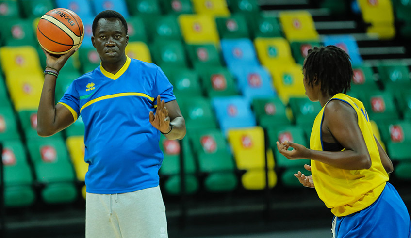 National Basketball team head coach, Cheikh Sarr gives instructions to players during a training session at Kigali Arena. / Dan Nsengiyumva.