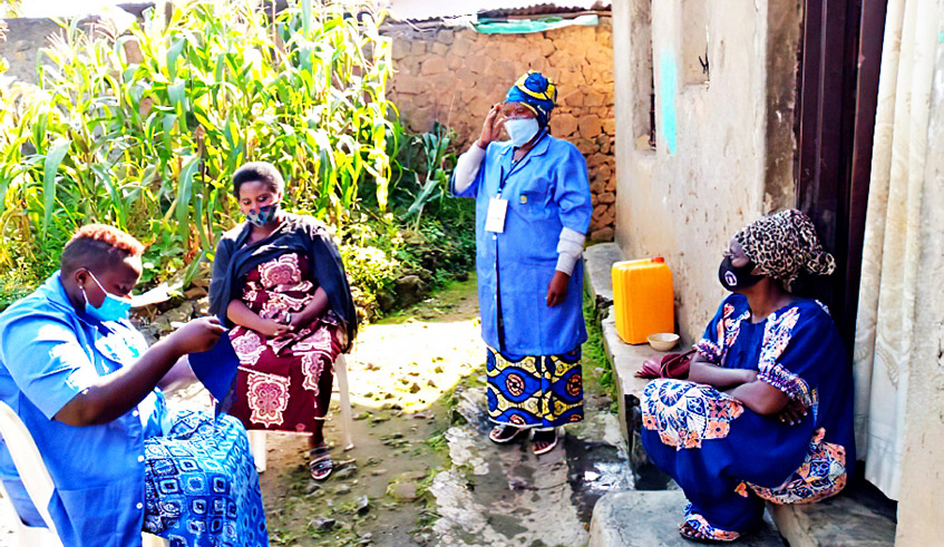 Community health workers during a door-to-door sensitisation exercise on how  to control the spread of Covid-19 in Kamonyi in April 2021. They have been at the forefront of fighting the virus. / Photo: Courtesy. 