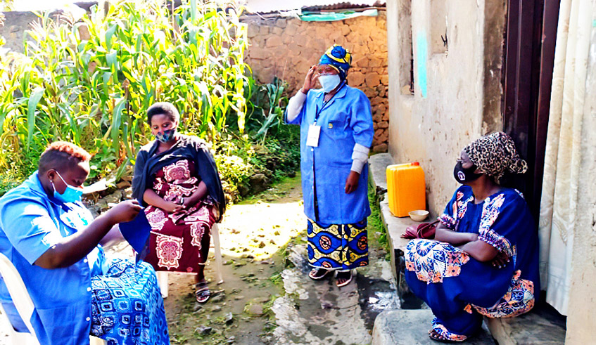 Community health workers during a door-to-door sensitisation exercise on how to control the spread of Covid-19 in Kamonyi in April 2021. They have been at the forefront of fighting the virus. / Photo: Courtesy. Community health workers during a door-to-door sensitisation exercise on how to control the spread of Covid-19 in Kamonyi in April 2021. They have been at the forefront of fighting the virus. / Photo: Courtesy.