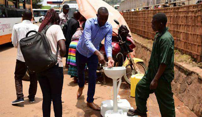 Passengers washing hands before boarding the bus. Experts stress that the current COVID-19 pandemic has yet again highlighted the critical role hand hygiene plays in disease transmission. / File photo.
