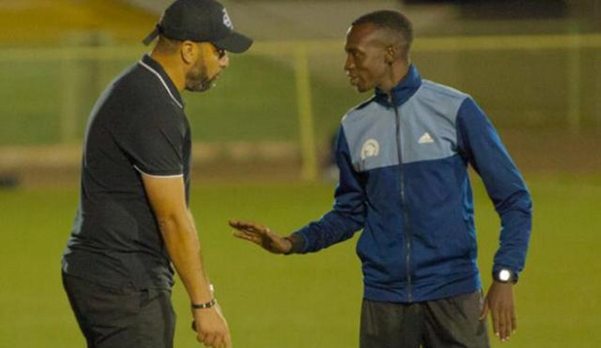 Vagne Muneza (R) speaks to APR FC head coach Mohammed Adil Erradi during a past league match at Kigali Stadium. / Photo: Courtesy.