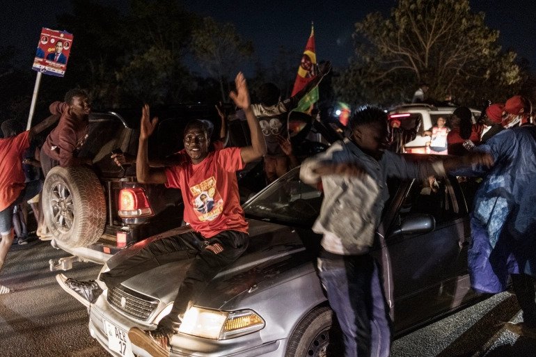 Supporters celebrate in front of the home of Hakainde Hichilema, declared the winner of Zambia's elections. 