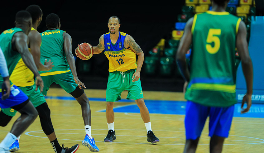 Veteran shooting guard Kenneth Gasana with the ball prepares to shoot during a training session at Kigali Arena early this year. Gasana is one of the key players for the national team ahead of the Afro-basketball tourney. / Dan Nsengiyumva.