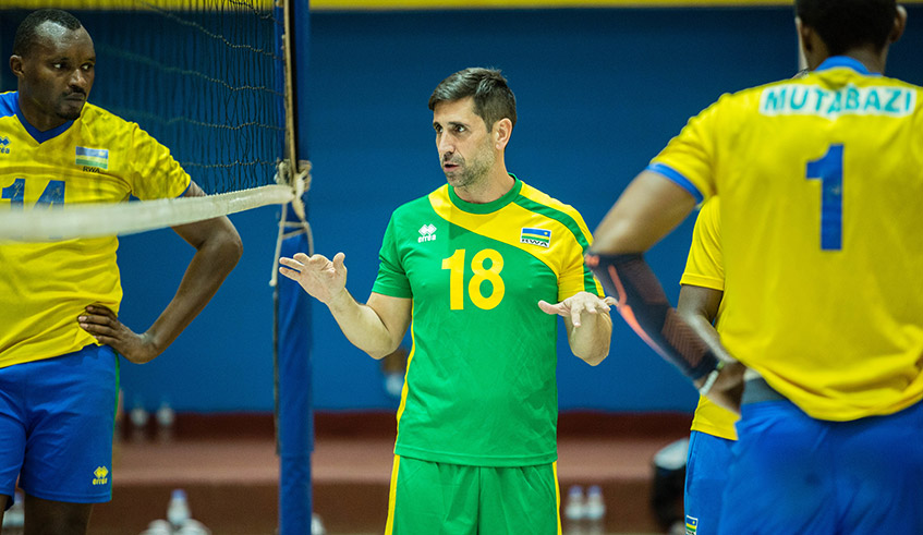 The national volleyball team head coach Paulo de Tarso talks to his players during a training session on August 10, 2021. The winner of the tournament will book a ticket to the 2022 FIVB Volleyball menu2019s World championship slated from in September 2022 in Russia. / Dan Nsengiyumva.