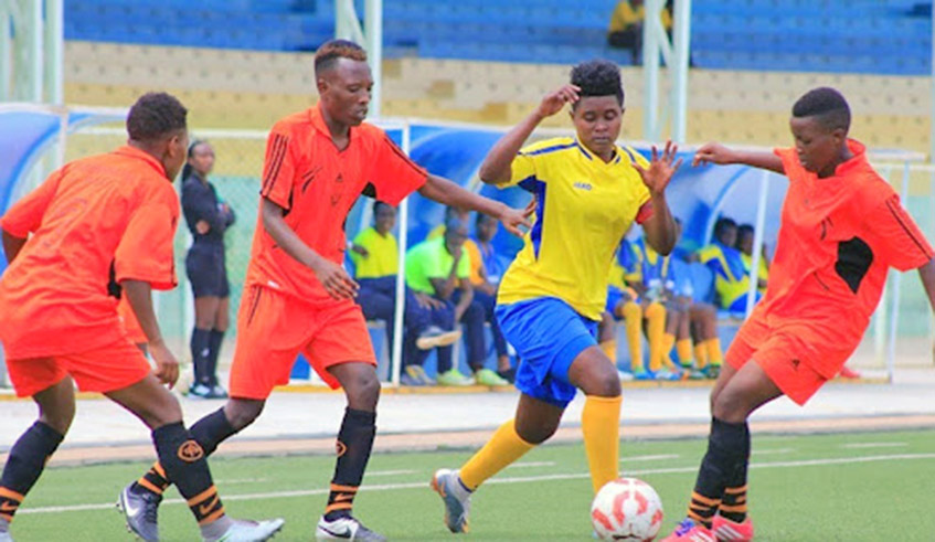 AS Kigaliu2019s women football club striker, Alice Kalimba (centre) dribbles past Scandinavia defenders during a past league match at Kigali Stadium. The 2021/22 women football season is set to start in November. Scandinavia are the defending champions having won the 2018/19 league title. / Photo: File.
