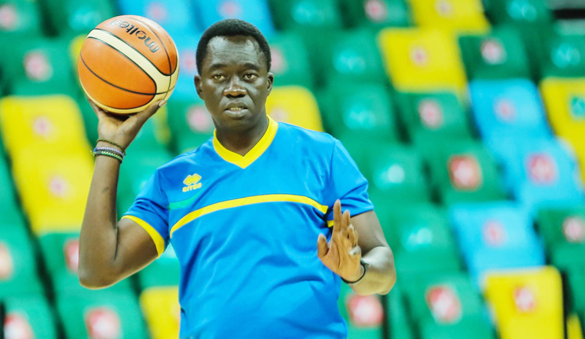 National Basketball team head coach, Cheikh Sarr gives instructions to players during a training session at Kigali Arena. / Dan Nsengiyumva