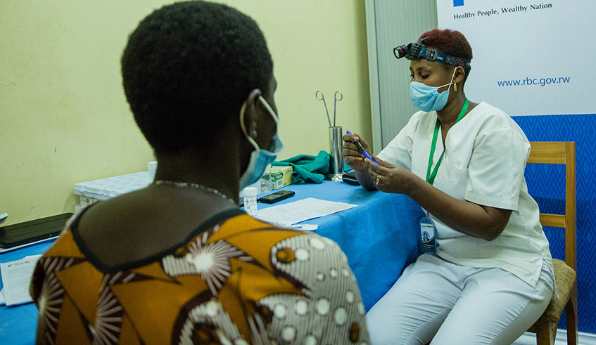 A medical worker screens a woman for cervical cancer at the launch of an awareness campaign about the disease on September 7. The campaign, dubbed Educate, Screen and Treat (EST), was launched at Ntarama Health Centre in Bugesera District. / Photo: Dan Nsengiyumva.