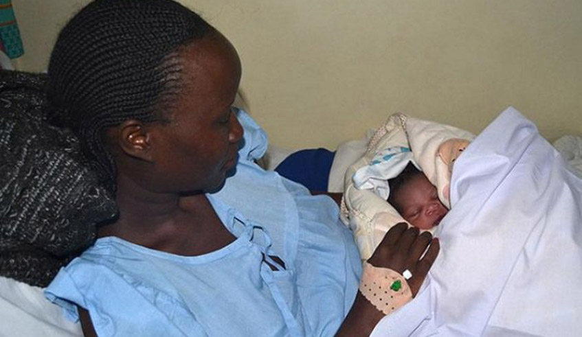 A mother holds her baby after giving birth in Kigali. The civil society has suggested that new fathers be granted paternity leave days equivalent to half of the new mothersu2019. / Photo: Courtesy.