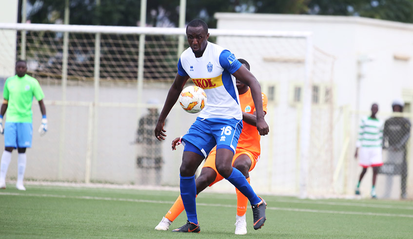 Rayon Sports striker Ernest Sugira shields the ball from a Gasogi defender in a past league match. The Blues are slated to resume training this week. / File.