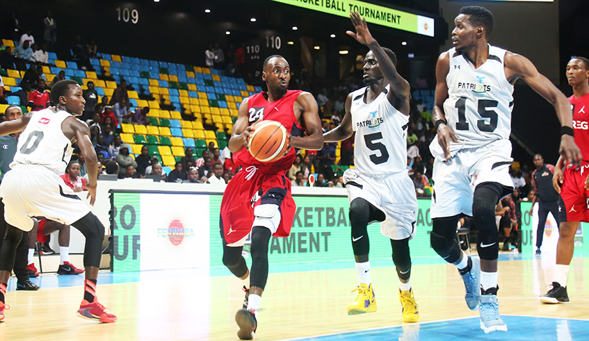 REG point guard Ali Kubwimana Kazingufu tries to get past Patriots players during a past league encounter at the Kigali Arena. The national basketball league resumes on September 17. / Sam Ngendahimana
