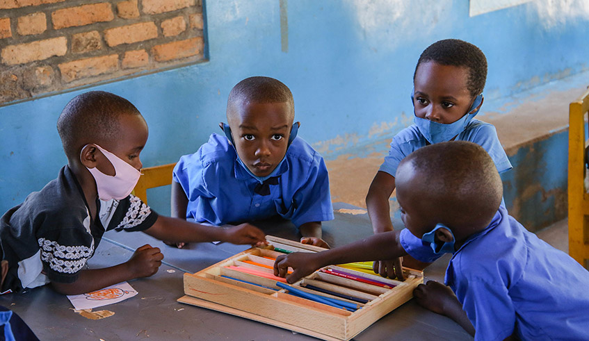 Children use coloured pencils during a drawing lesson at Nyarugunga Early Childhood Development Centre in June. / Photo: Dan Nsengiyumva.