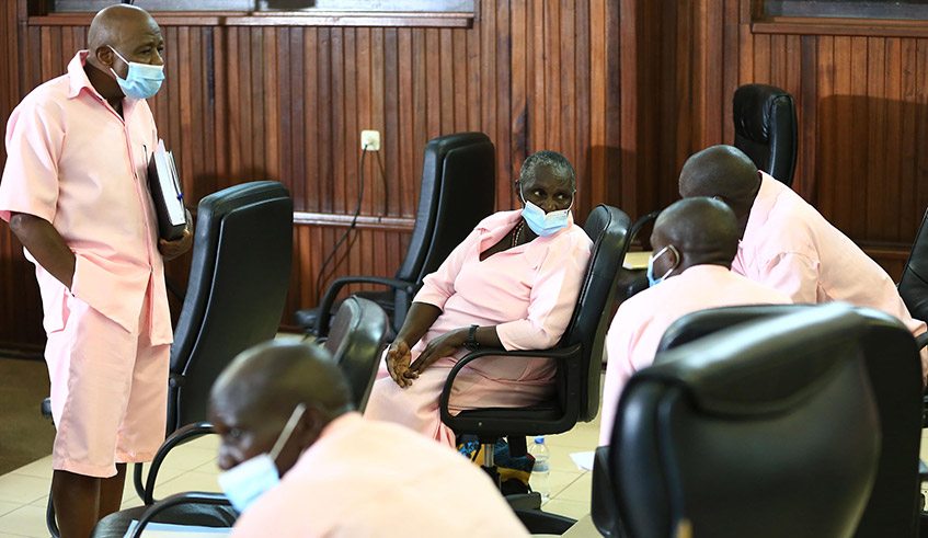 Rusesabagina (left) interacts with his co-accused in the MRCD-FLN trial in the Supreme Court chambers on March 5, 2021. / Photo: Sam Ngendahimana.