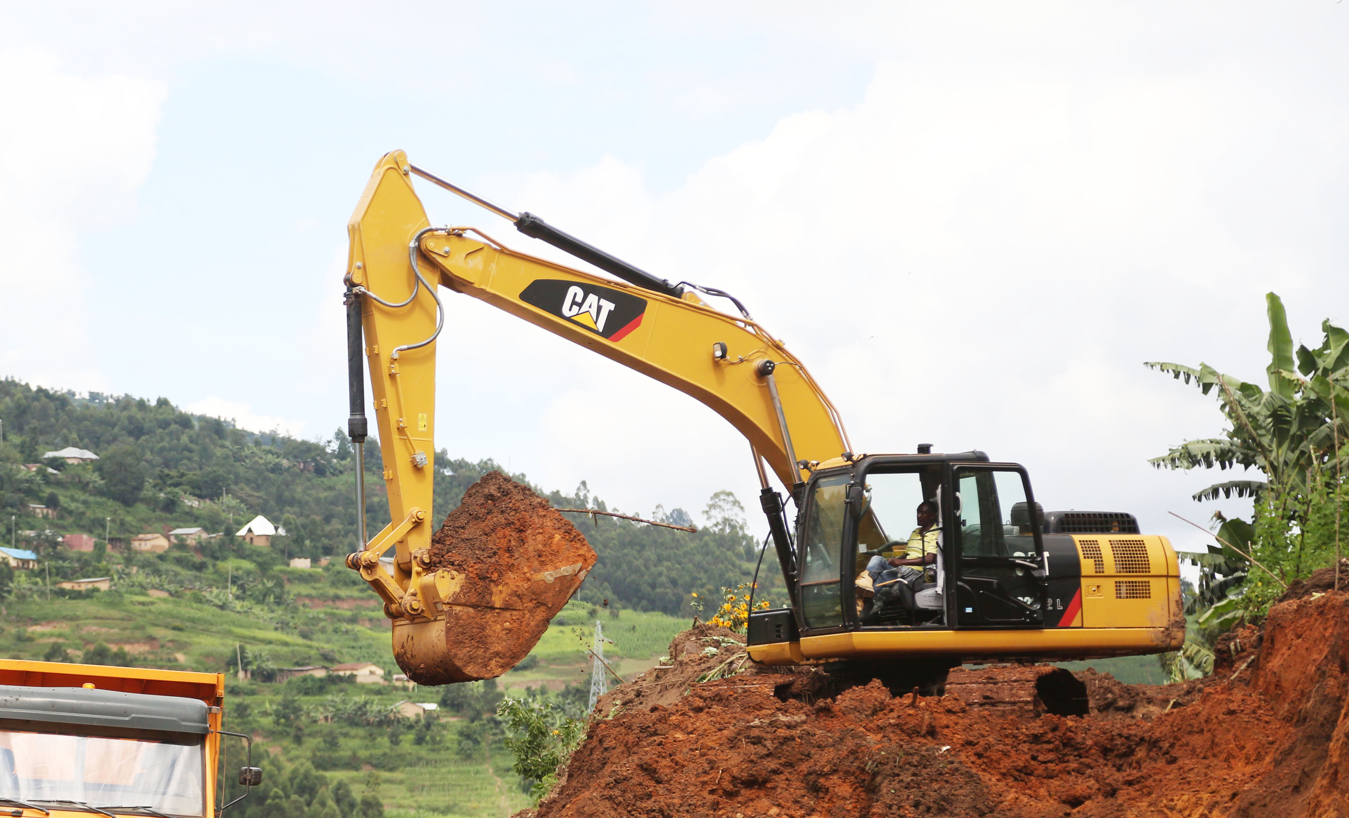 An excavator works at a road construction site in Rwanda. Photo by Sam Ngendahimana