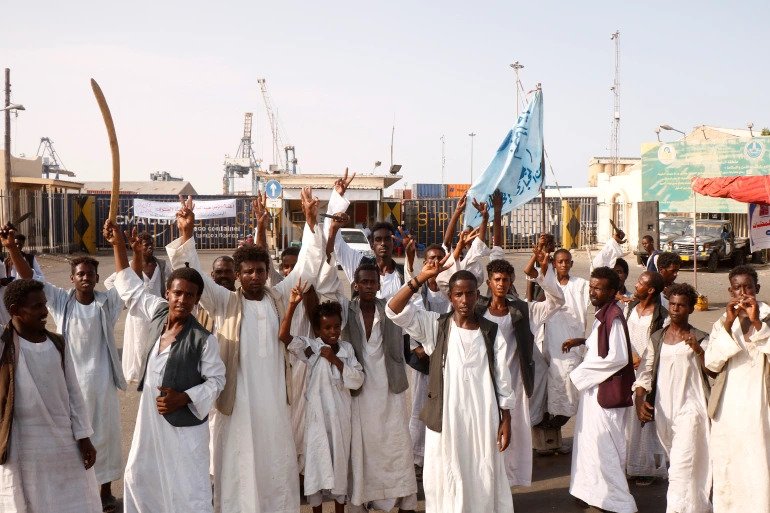 Sudanese protesters gather outside the main entrance to the southern port in Port Sudan. 