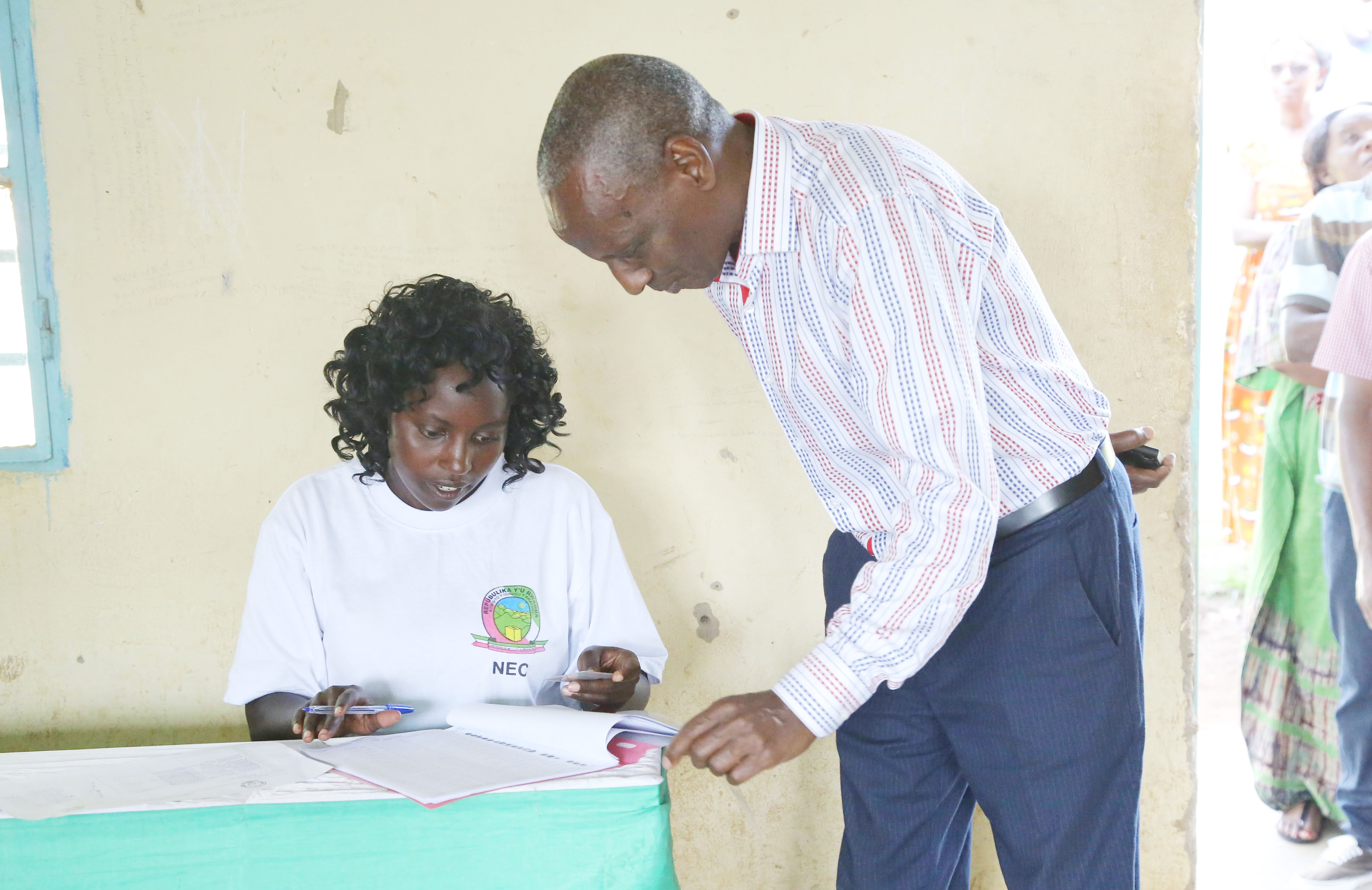 A voter checks his identification  during the election . Photo by Sam Ngendahimana