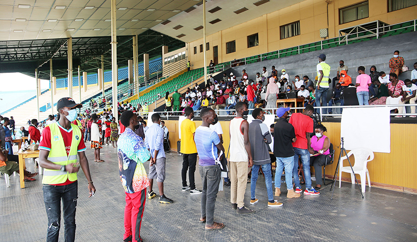 Some of the youth who turned up for taking of their photographs to allow them get their national identity cards at Amahoro National Stadium in Remera. According to NIDA, the exercise was suspended early last year following the outbreak of Covid-19. / Photo: Craish Bahizi. 