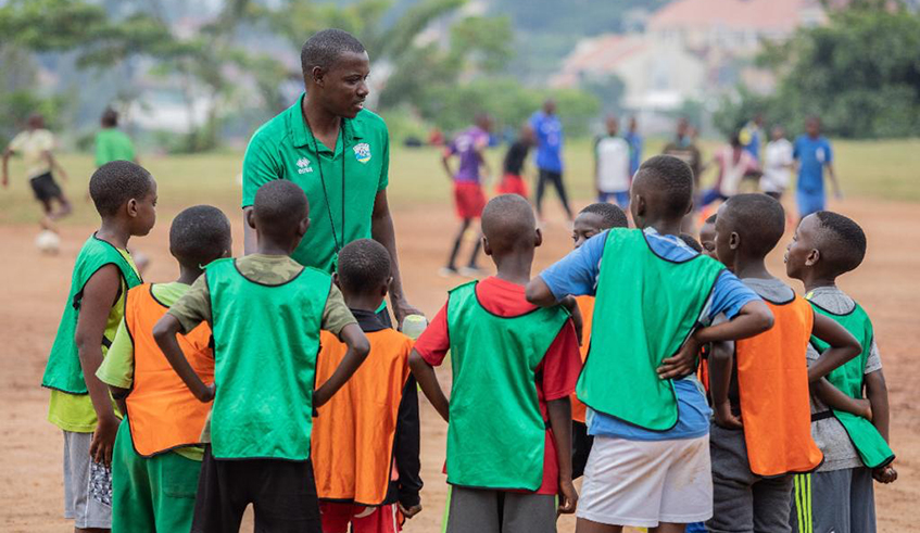 Jimmy Mulisa interacts with some of the players at his football Academy foundation which has bases in Kigali and Rulindo districts respectively. / Courtesy.