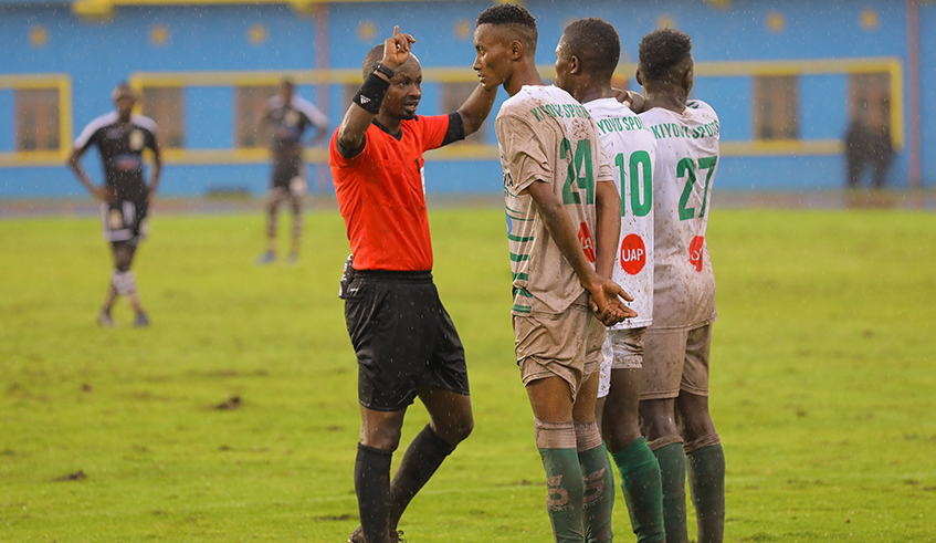 SC Kiyovu players listen to the referee's instructions during a past league match against APR FC at Amahoro Stadium last season . / Sam Ngendahimana