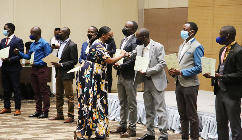 Education minister Valentine Uwamariya congratulates teachers who were awarded certificates of appreciation during the celebrations of the World Teacherâ€™s Day in Kigali on Tuesday, October 5. Teachers are seeking the help of the government to pay back the loans they acquired from Umwalimu Sacco, their savings and credit cooperative. 