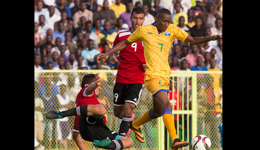 Former Amavubi midfielder Jean Baptiste Mugiraneza dribbles past Morocco players at Kigali stadium in a previous match. Mugiraneza has tipped the national team to defeat the Uganda Cranes in the 2022 world cup qualifier on Thursday. / Photo: Sam Ngendahimana.