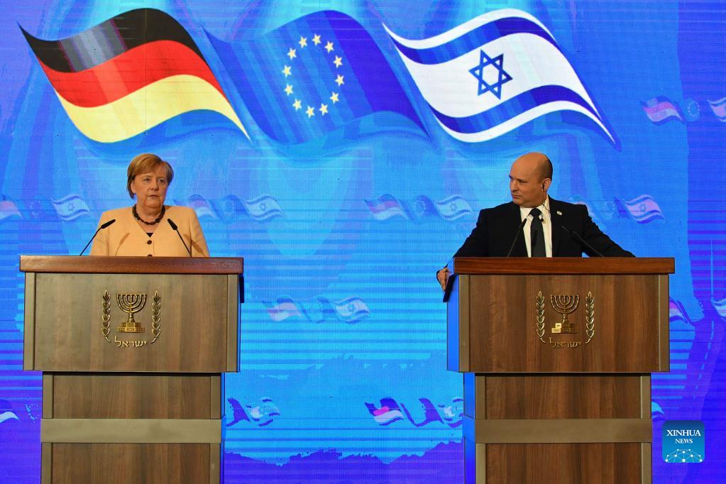 Israeli Prime Minister Naftali Bennett and German Chancellor Angela Merkel attend a joint press conference at the King David Hotel in Jerusalem, Oct. 10, 2021. 