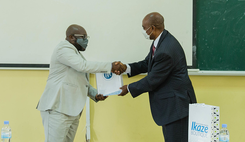 Gilles Evrard Mayagui Manamy, Technical Advisor of Gabon Scholarship Agency (left), shakes hands with Nosa O. Egiebor, University of Rwandaâ€™s Deputy Vice-Chancellor in charge of academic affairs and research, during the signing of an agreement that allows students from Gabon to undertake their undergraduate studies at UR, in Kigali on Monday, October 11. / Photo: Dan Nsengiyumva.