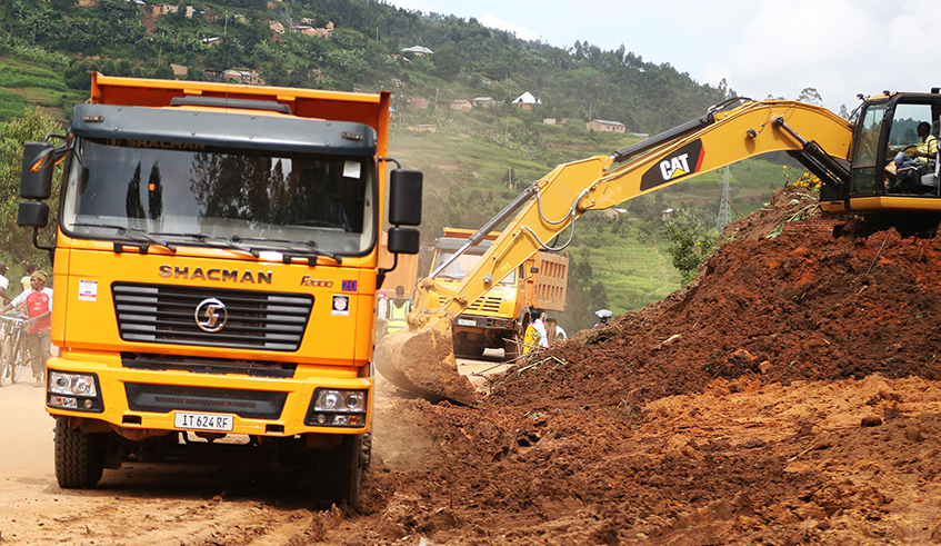 An excavator and trucks during road construction works in Gicumbi District. / Photo: Sam Ngendahimana.