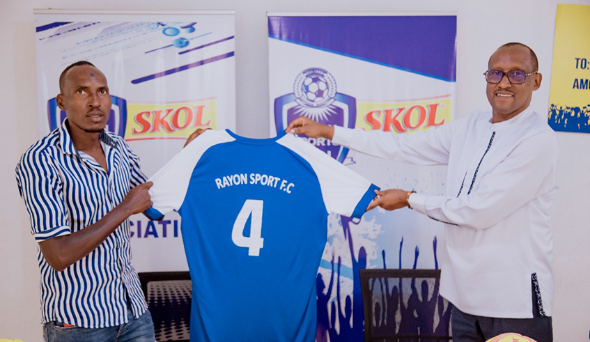 Karim Mackenzie Nizigiyimana shows off his jersey after signing a new deal at Rayon Sports. / Courtesy