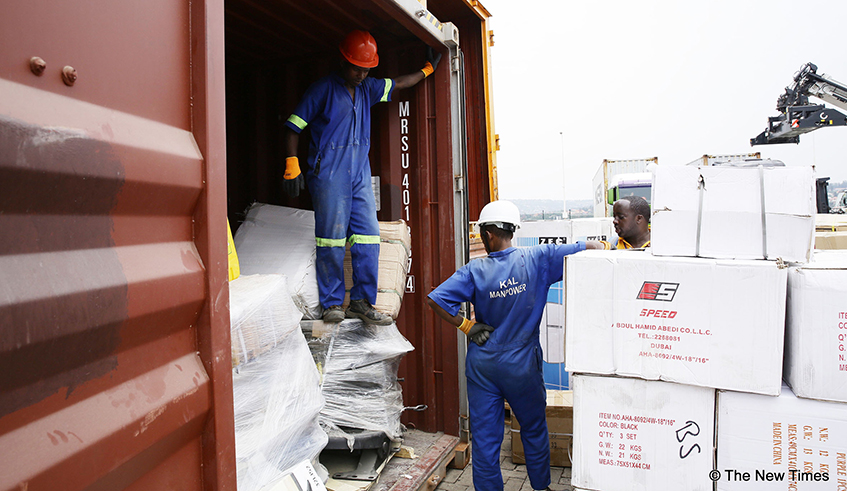 Workers unload a cross-border truck at DP World Kigali Logistics Platform. / Photo: File.
