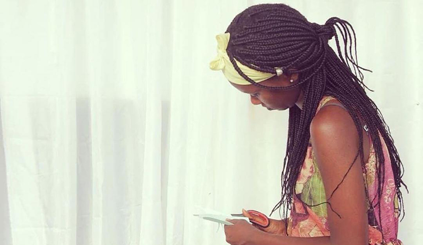 Damaris Uwase making a paper flower. / Courtesy photo