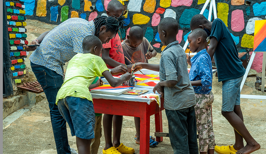 Nizeyimana makes art pieces with the kids.  / Photos by Willy Mucyo