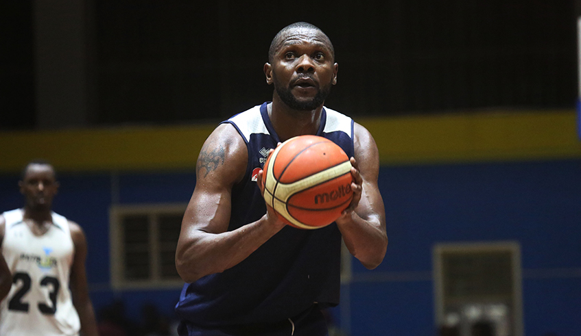 REG basketball player Kami Kabange prepares to shoot during a past match against Patriots. Kabange and his wife both play for REG men and women basketball clubs respectively. / Photo: Sam Ngendahimana.