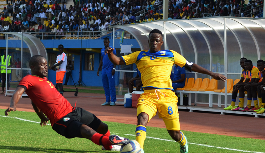 National Football captain Haruna Niyonzima dribbles past a Mozambique defender during a past match at Amahoro National Stadium. / Photo: Sam Ngendahimana.