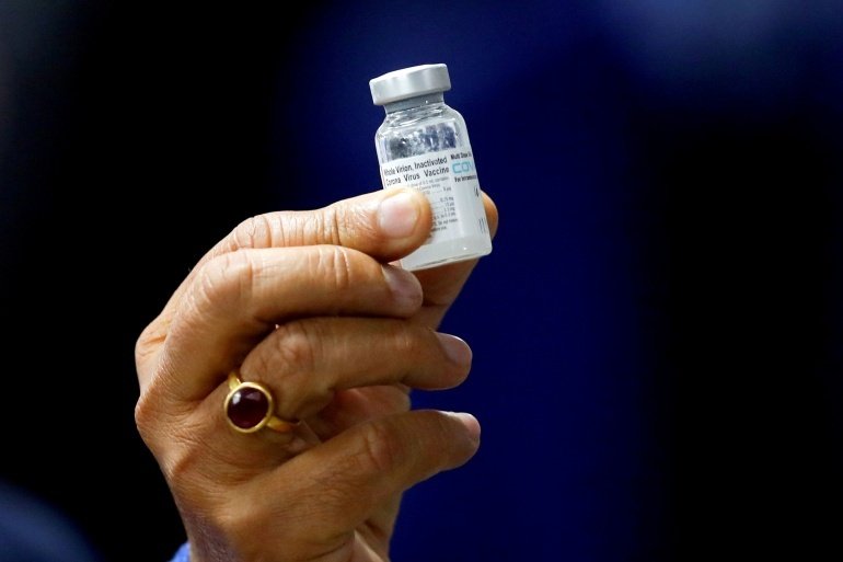 Former Indian Health Minister Harsh Vardhan holds a dose of Covaxin during a vaccination campaign at the All India Institute of Medical Sciences (AIIMS) hospital in New Delhi. 