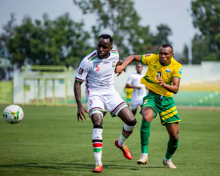 Amavubi striker Jacques Tuyisenge vies for the balll with a Harambe Stars defender at Kigali Stadium. 