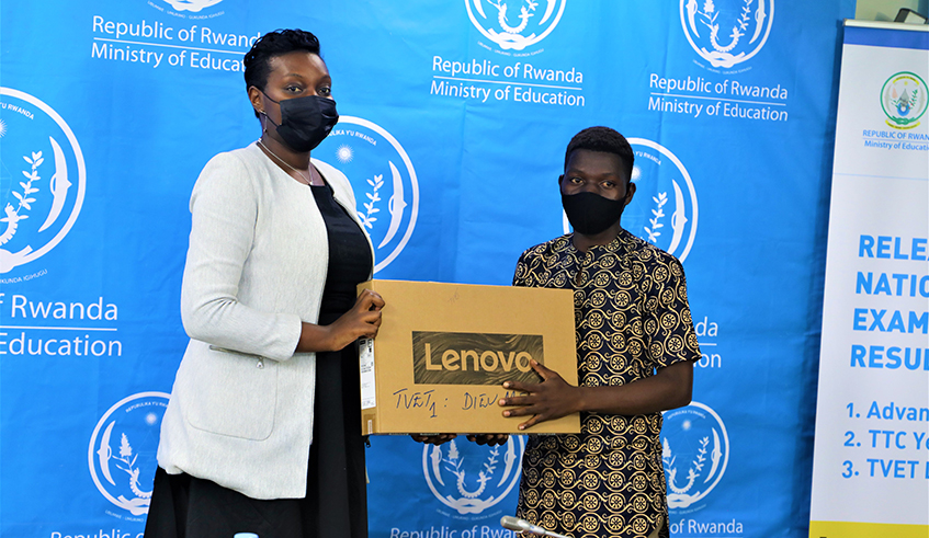 Dieu Merci Mugisha, the best performer in TEVT schools gets his laptop during the event to release Senior six national examination results in Kigali on November 15. / Craish Bahizi