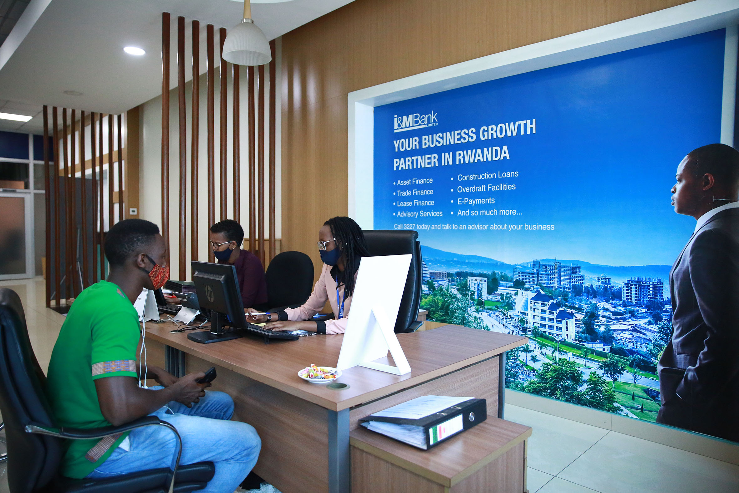I&M Bank staff attend to a customer at Kigali Height branch. Rwandan millennials, born between 1981 and 1996, dominate the banking sectoru2019s borrowing market, at 56.4 per cent, ahead of Gen X, born between 1965 and 1980, who are at 21.5 per cent, the latest credit data shows. 