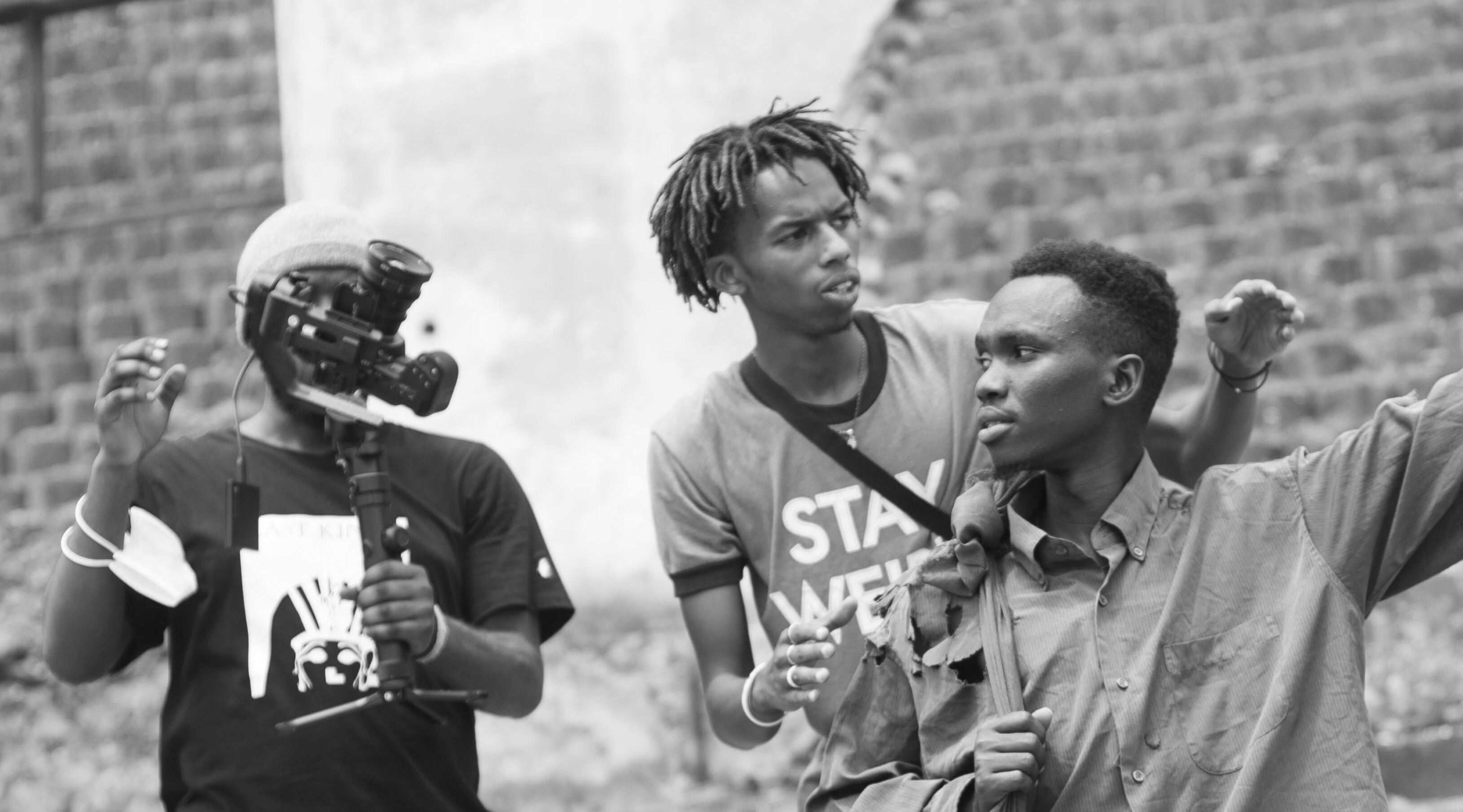 Khalid Steve Shema (C), the poem director, and David Ndagijimana, commonly known as No Stress, during the shooting of u2018The Joiin of Threeu2019 poem.