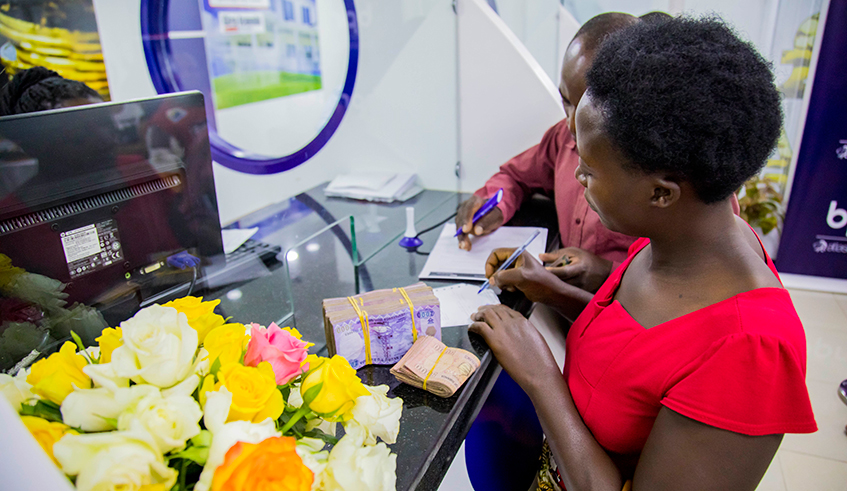 A customer withdraws money at BPR Nyabugogo branch. Remittance inflows to Rwanda for 2021 are estimated at around $246 million after a drop to $241 million in 2020. / Photo: File.