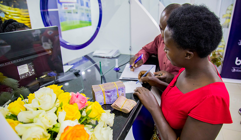 A customer withdraws money at BPR Nyabugogo branch. Remittance inflows to Rwanda for 2021 are estimated at around $246 million after a drop to $241 million in 2020. / Photo: File.