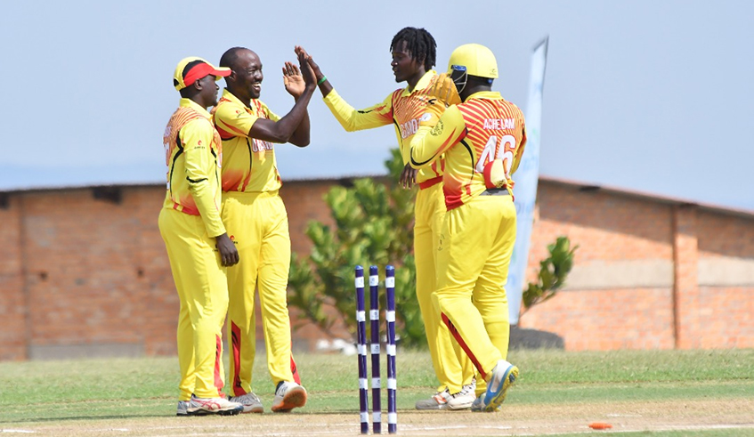 Uganda's Cricket team players celebrate after securing ticket the the ICC Men's T20 World Cup Gl;obal Qualifier with hard-fought victory over Kenya on Saturday, November 20, at Gahanga Cricket Stadium. / Courtesy