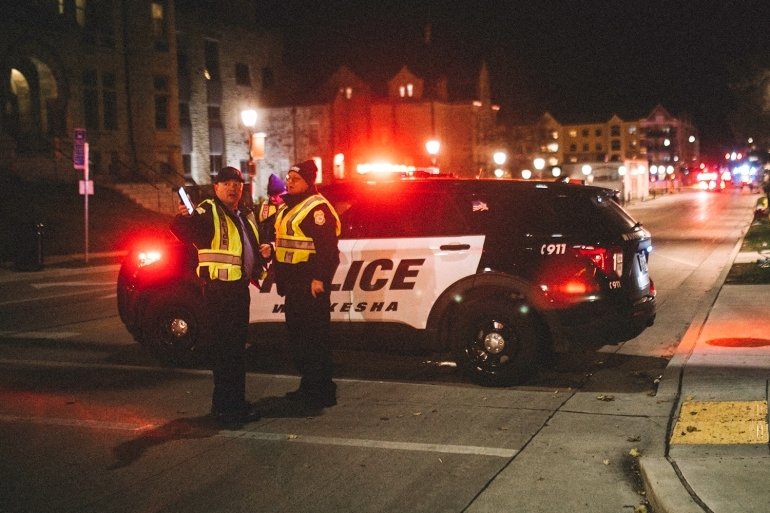 Police and emergency personnel respond to the scene after a car ploughed through a holiday parade in Waukesha, Wisconsin. 