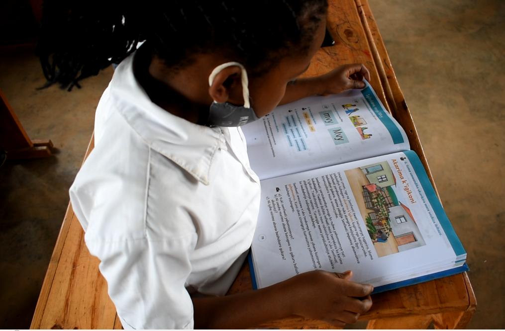 A child reads Kinyarwanda at school. 