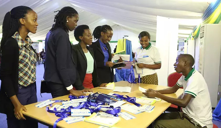 Job seekers at an information desk during an open day where potential employees meet job providers to explore opportunities. Job insecurity is a concern in most countries, including those with advanced economies. / Photo: Sam Ngendahimana.