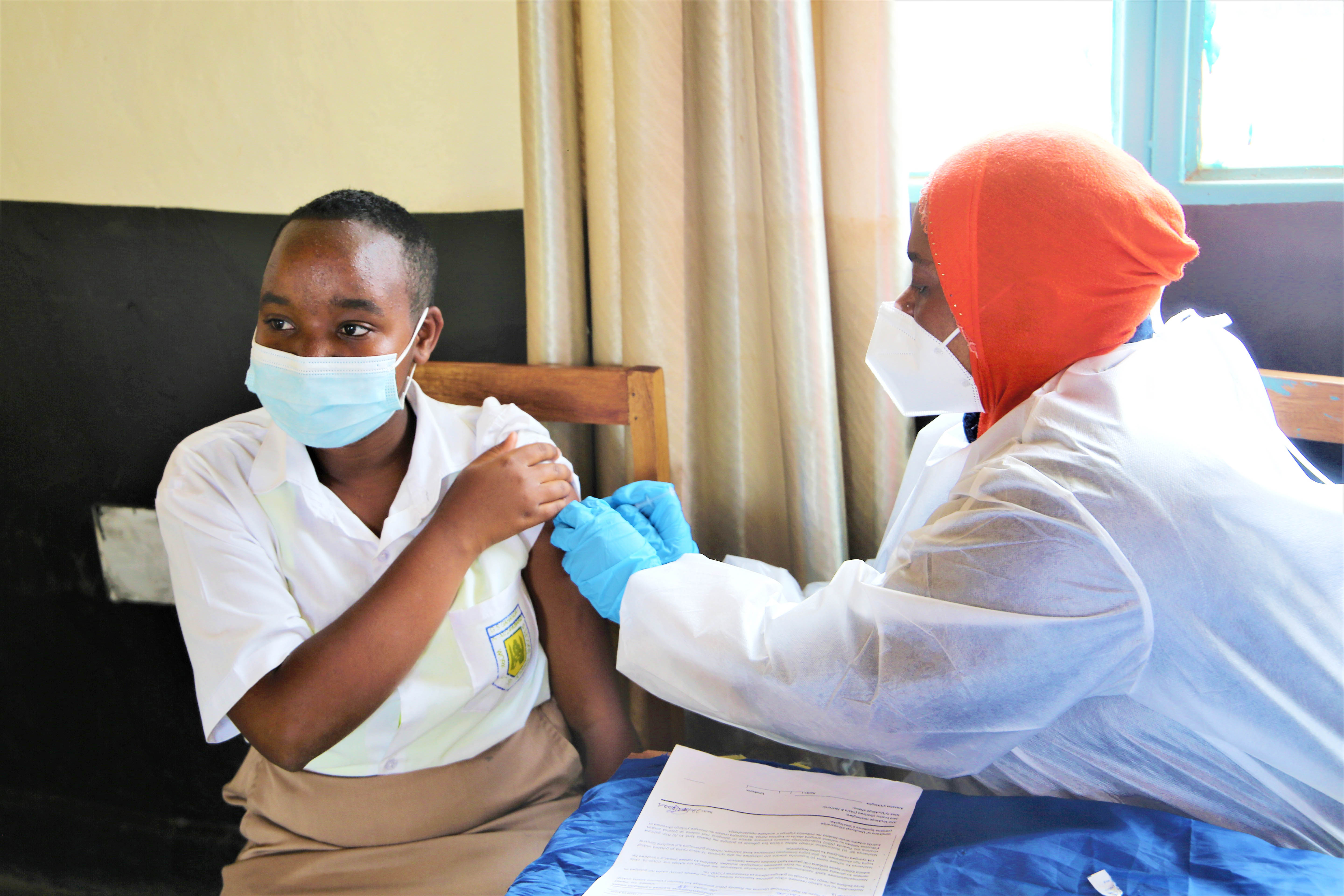 A secondary student recieves the Covid 19 dose as the country launches a vaccination exercise in schools on November 23. Craish Bahizi