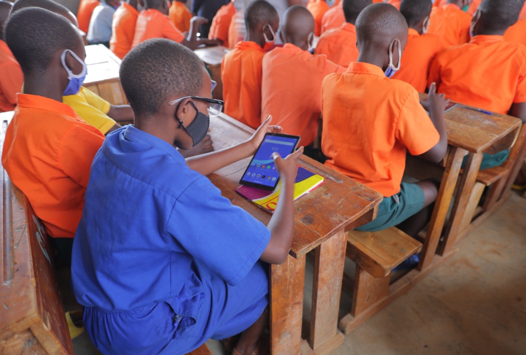 Students at GS Paysannat L C using tablet.