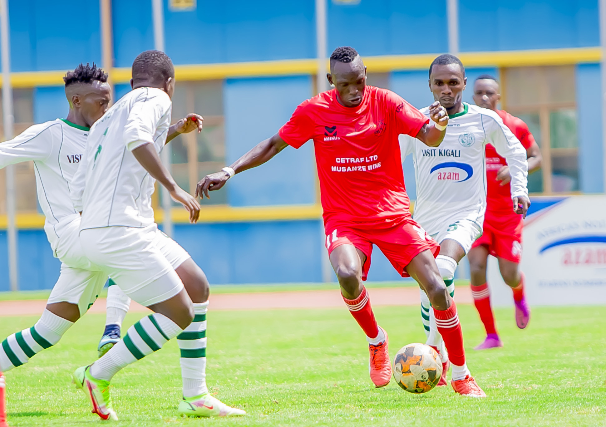 SC Kiyovu defenders and Musanze striker during the match at Amahoro Stadium. 