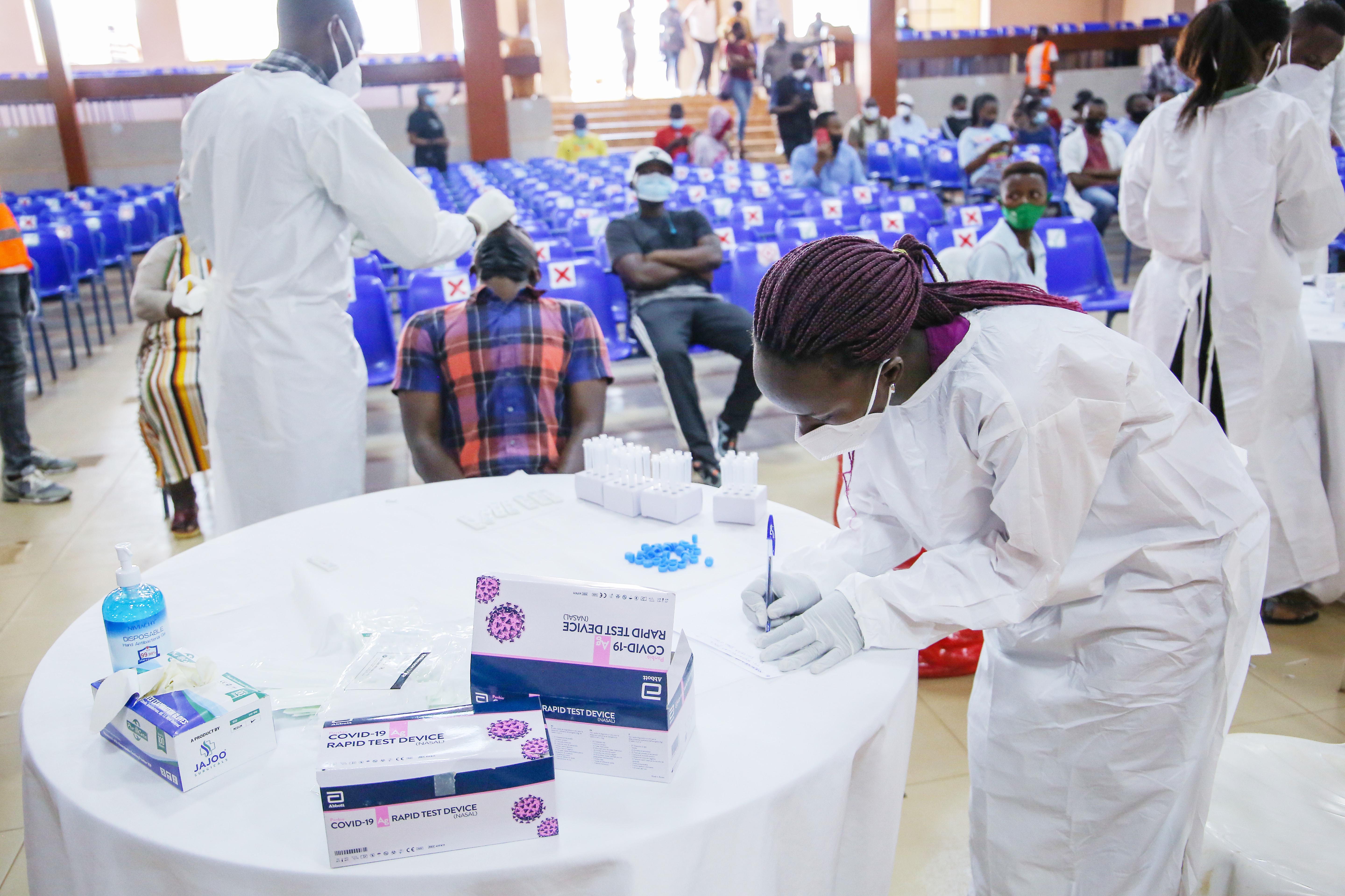 Health workers conduct the Covid 19 mass testing exercise in Nyamirambo in Kigali on July 23, 2021.Researchers in South Africa say that even though the Omicron variant of coronavirus spreads quickly, the resulting infection may be less severe than other forms of Covid-19. . Dan Nsengiyumva