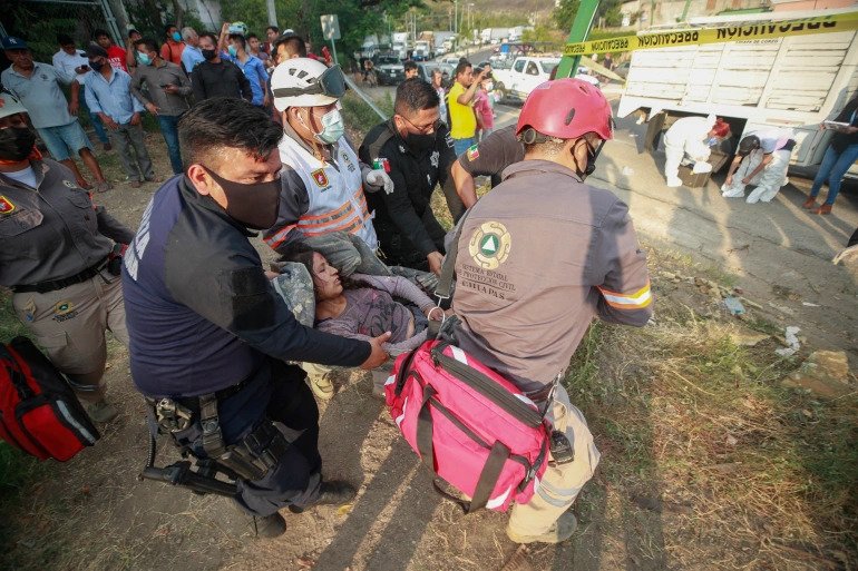 An injured woman is moved by rescue personnel from the site of a truck crash near Tuxtla Gutierrez, Chiapas state, Mexico. 